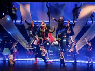 High-energy ensemble performing on Hughes Brothers Theater stage, an entertainment venue commonly referenced on a Branson Missouri city map for visitors planning show locations.